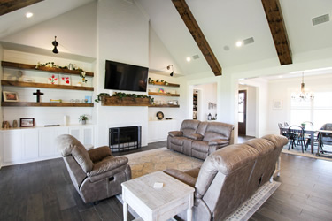 Open concept living space with cathedral ceiling and open shelving in East Texas